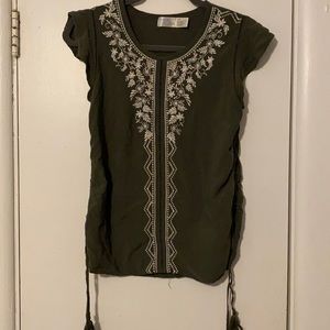 Green top with white detail and tassels